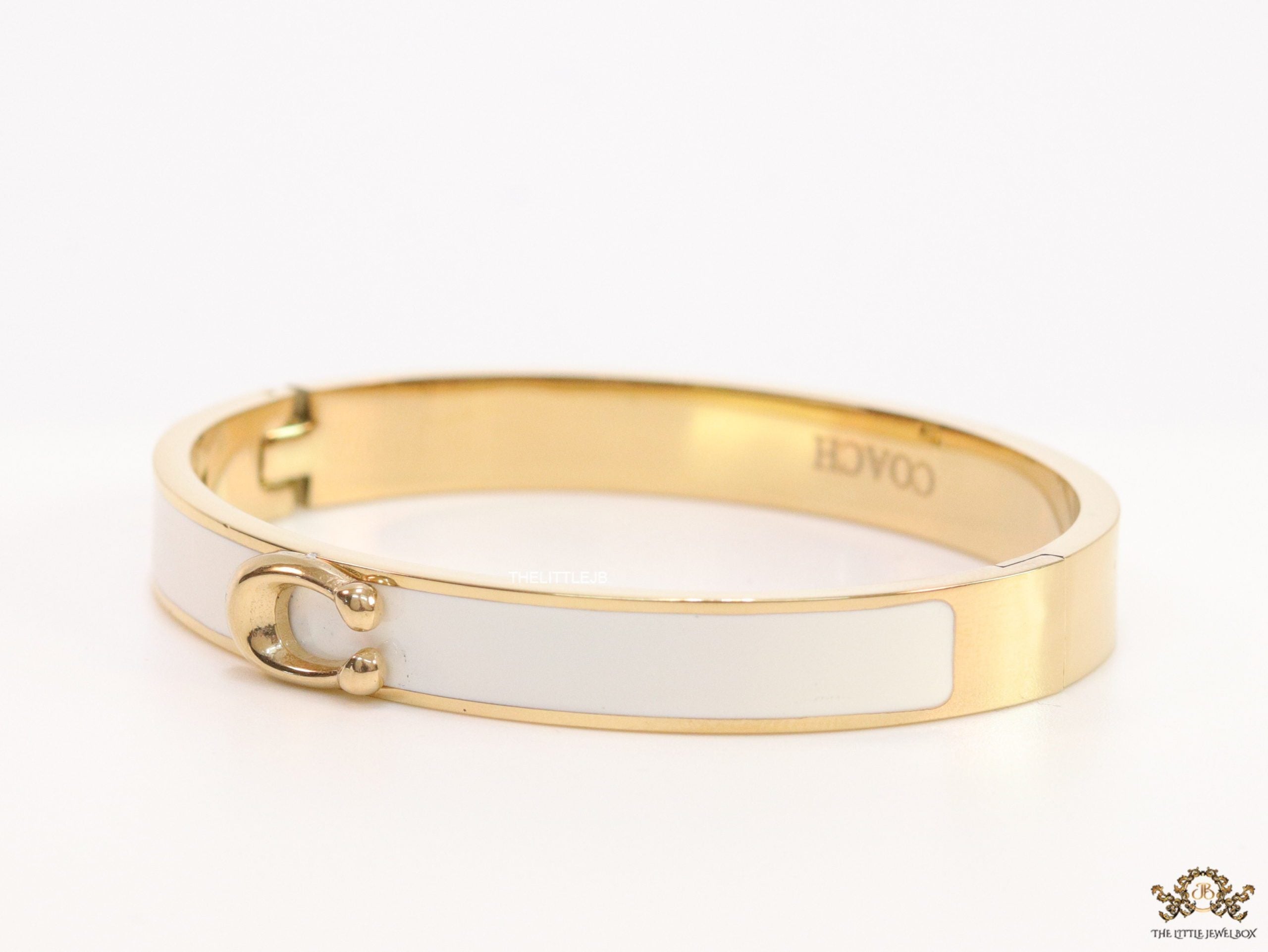 Sleek white and golden bracelet with C alphabet in centre