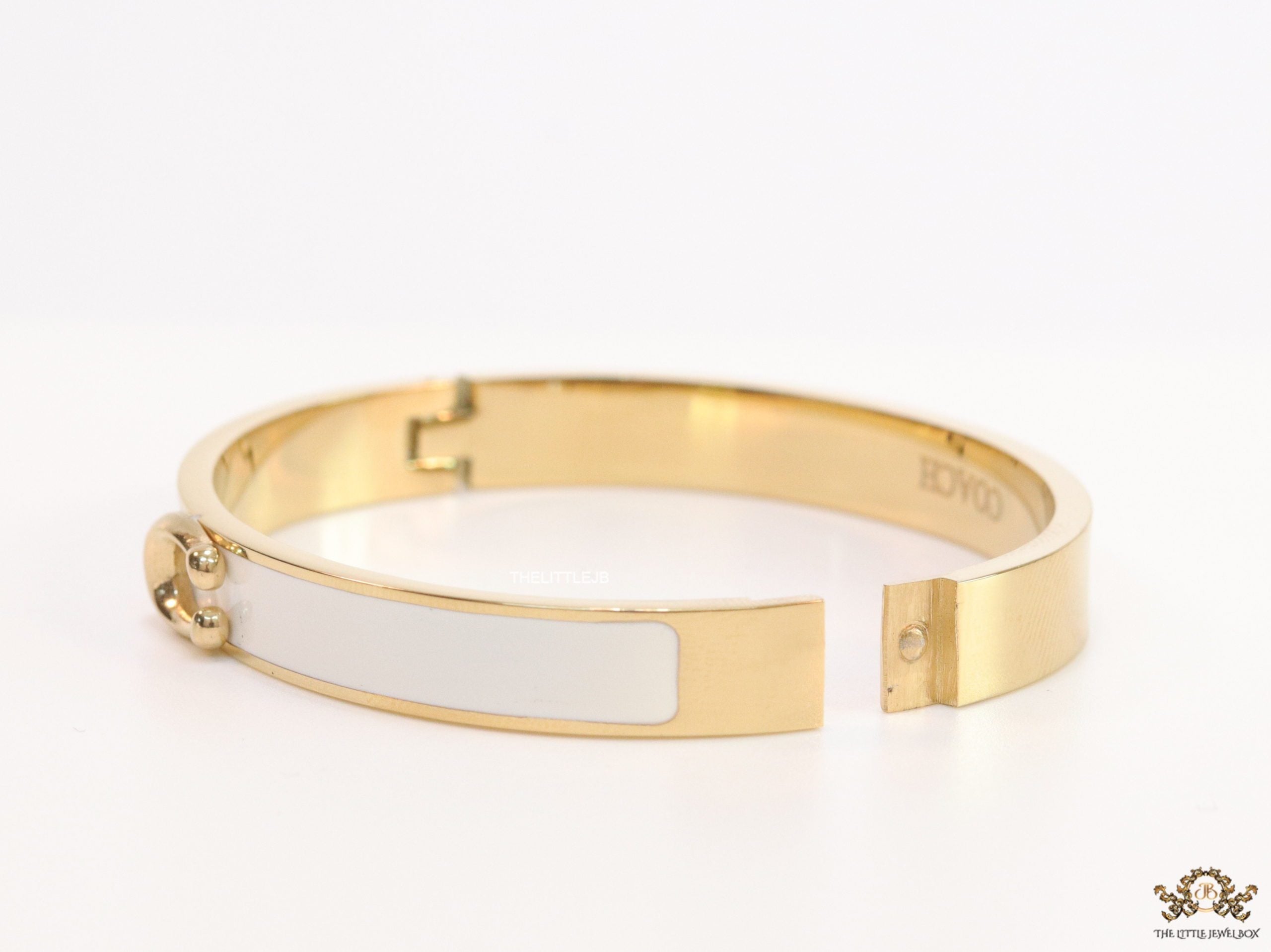Sleek white and golden bracelet with C alphabet in centre