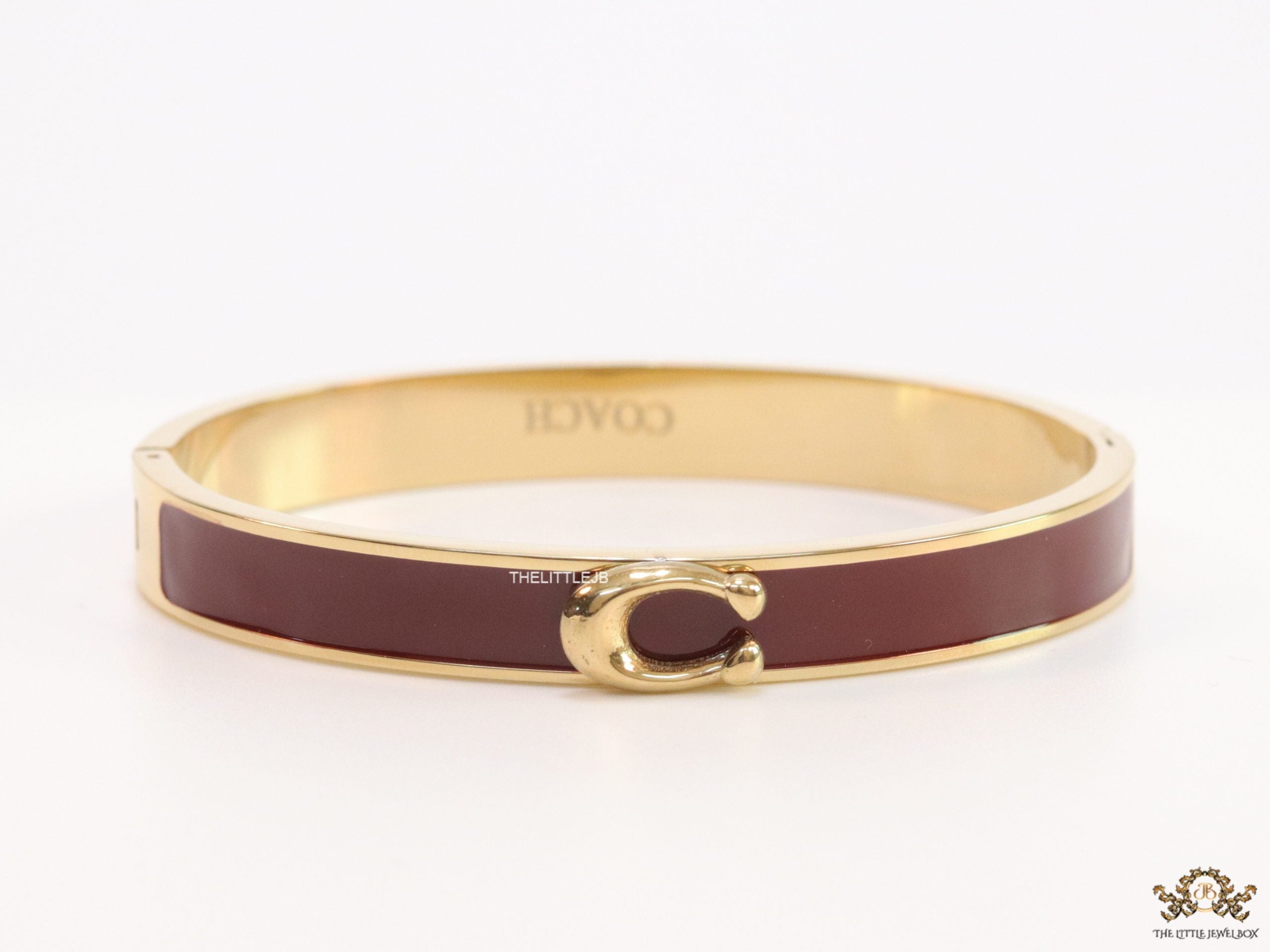 Sleek maroon and golden bracelet with C alphabet in centre