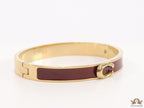 Sleek maroon and golden bracelet with C alphabet in centre