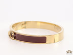 Sleek maroon and golden bracelet with C alphabet in centre