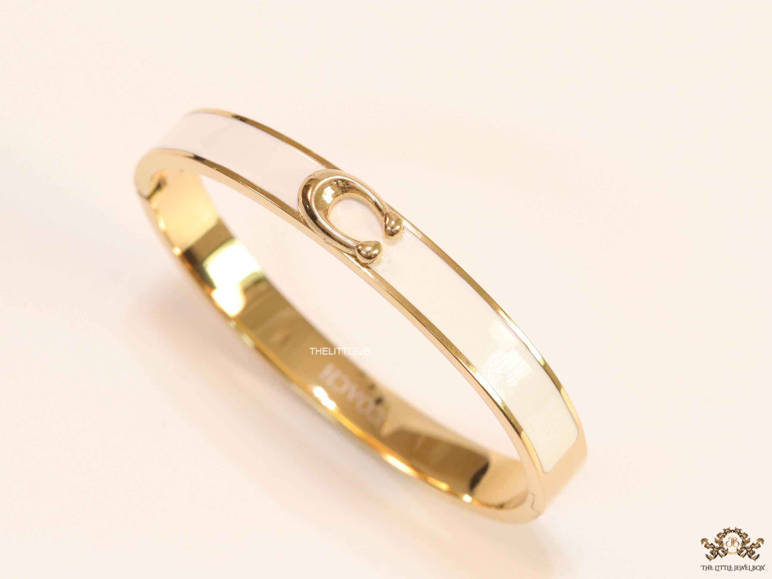 Sleek white and golden bracelet with C alphabet in centre