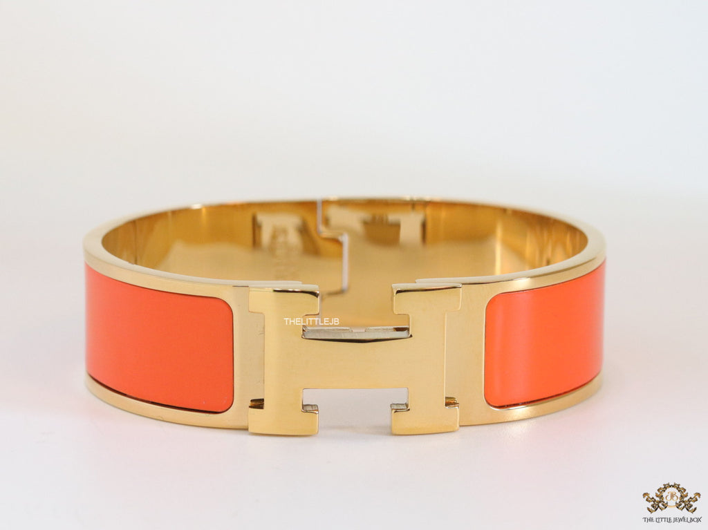 Openable H motif orange bracelet 18mm wide in a shiny gold plating