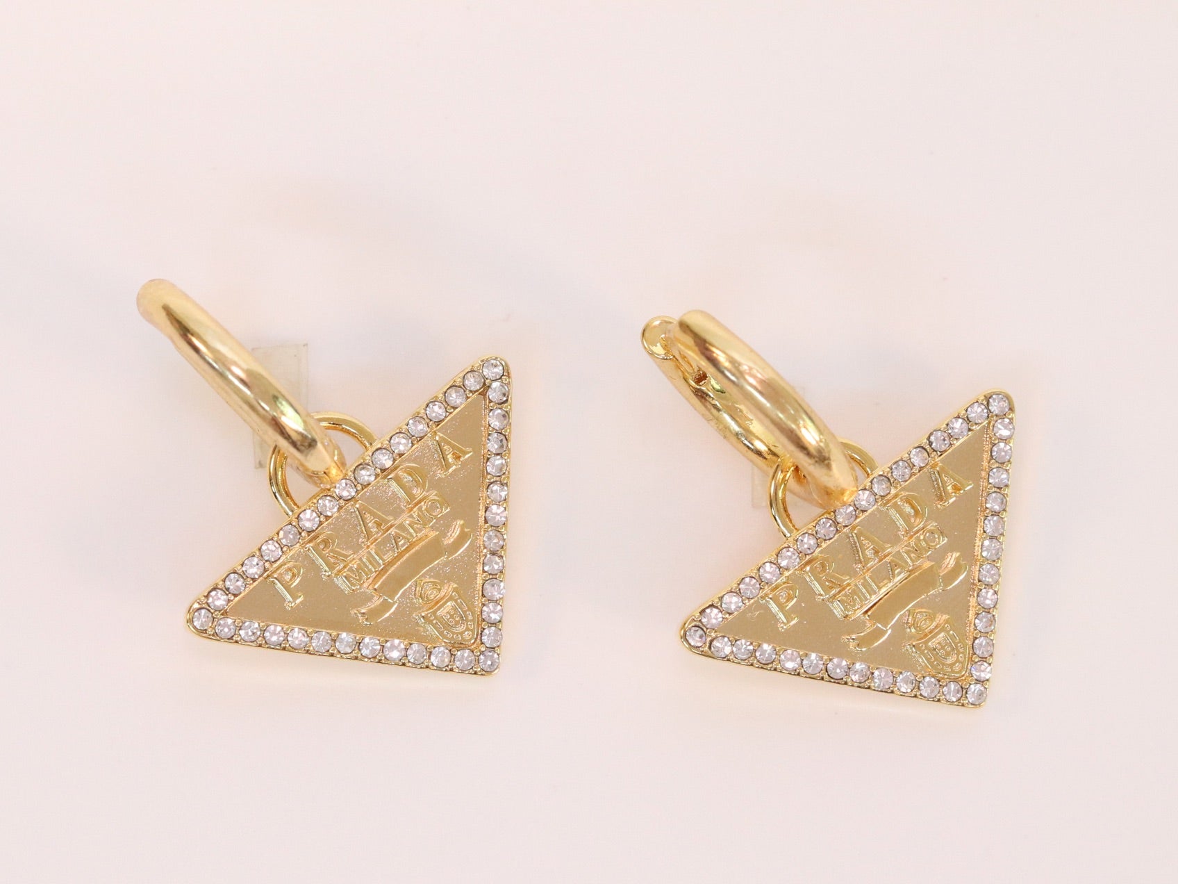 Gold Dangling Triangle earrings on small hoops with CZ