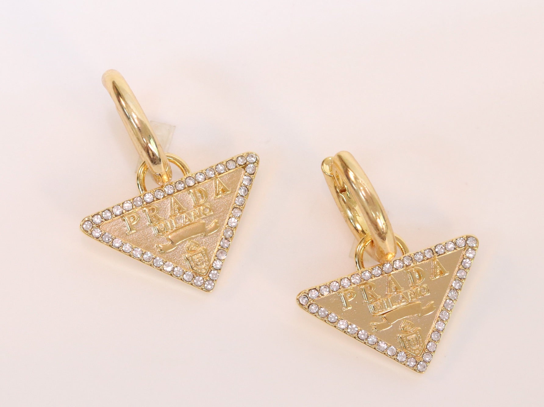 Gold Dangling Triangle earrings on small hoops with CZ