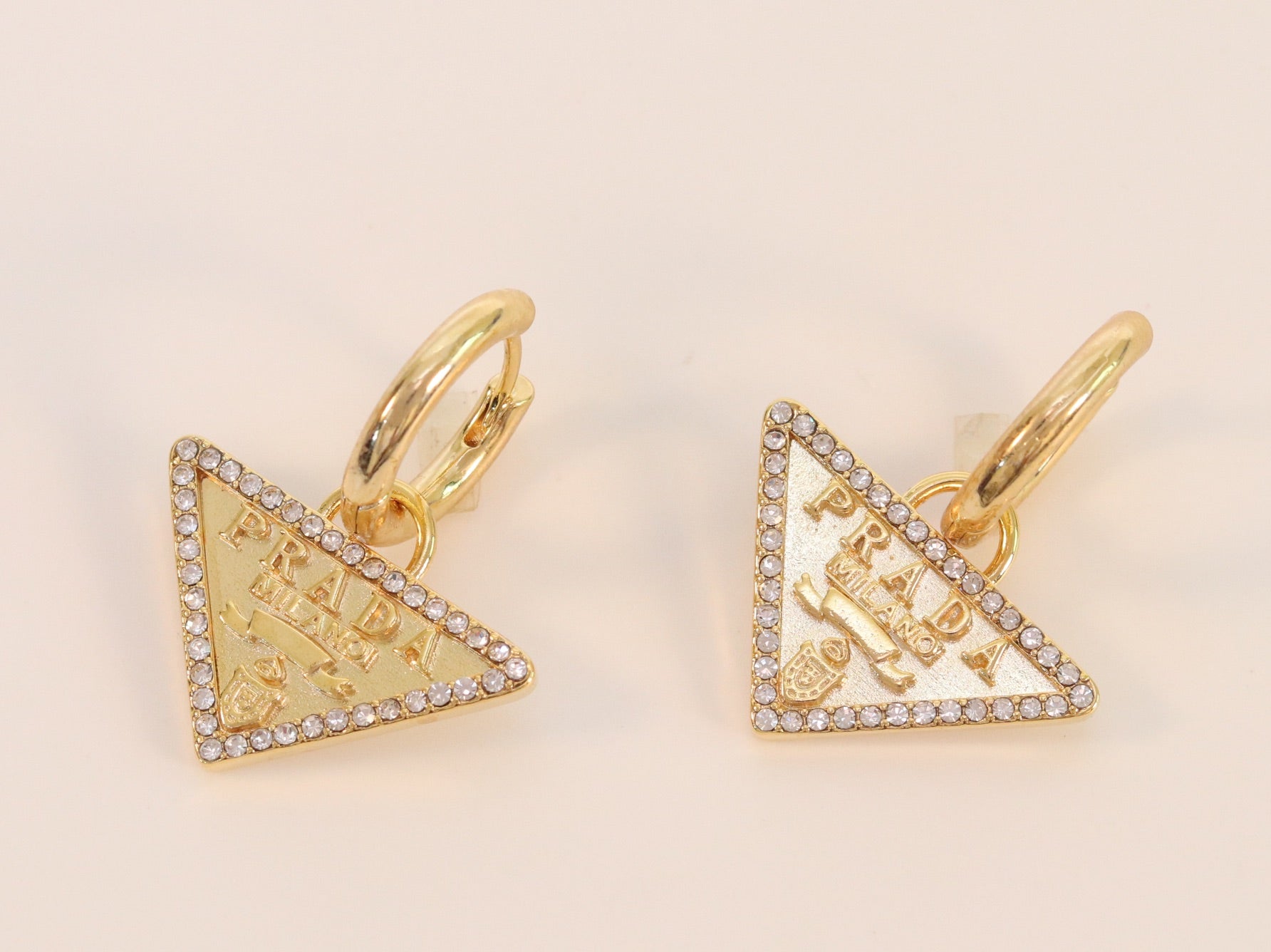 Gold Dangling Triangle earrings on small hoops with CZ