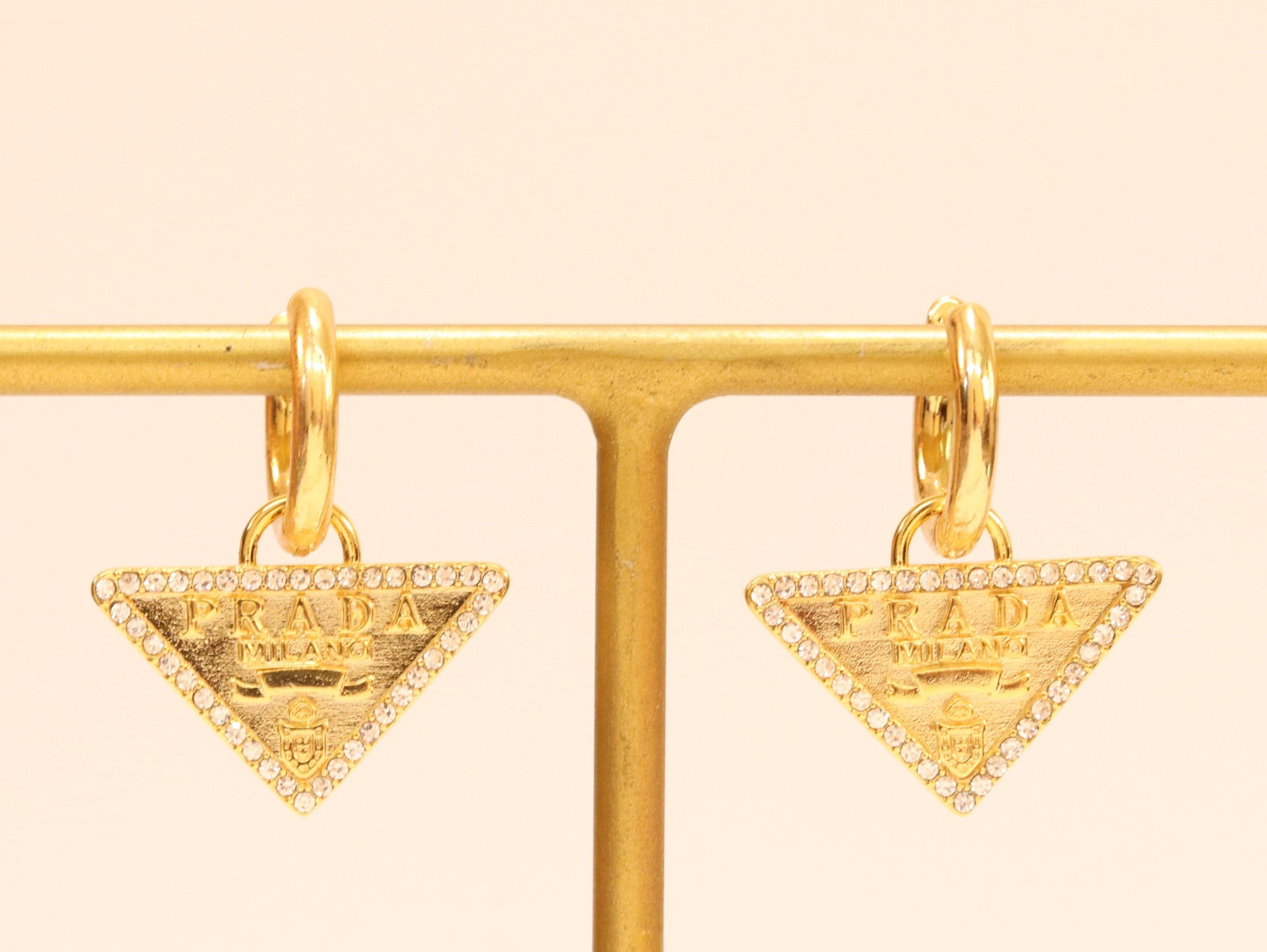 Gold Dangling Triangle earrings on small hoops with CZ