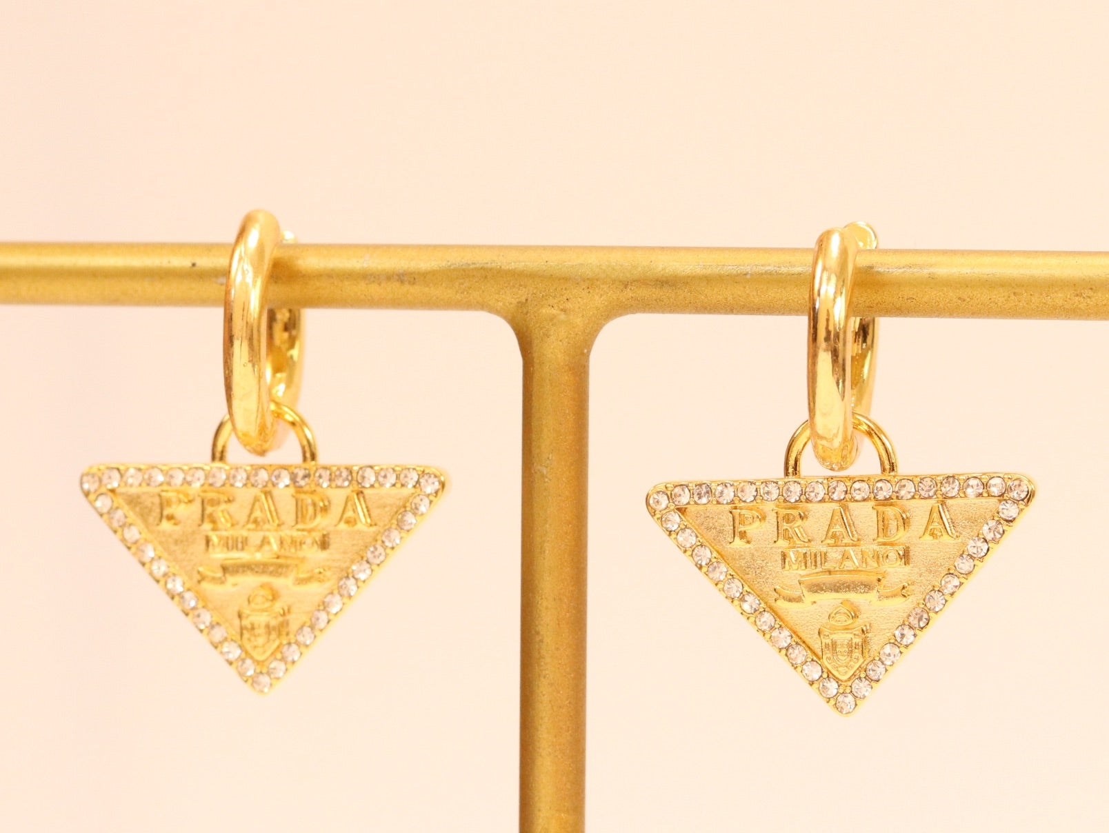 Gold Dangling Triangle earrings on small hoops with CZ