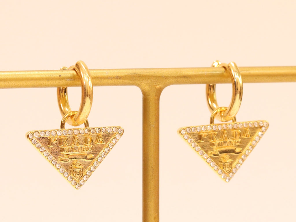 Gold Dangling Triangle earrings on small hoops with CZ