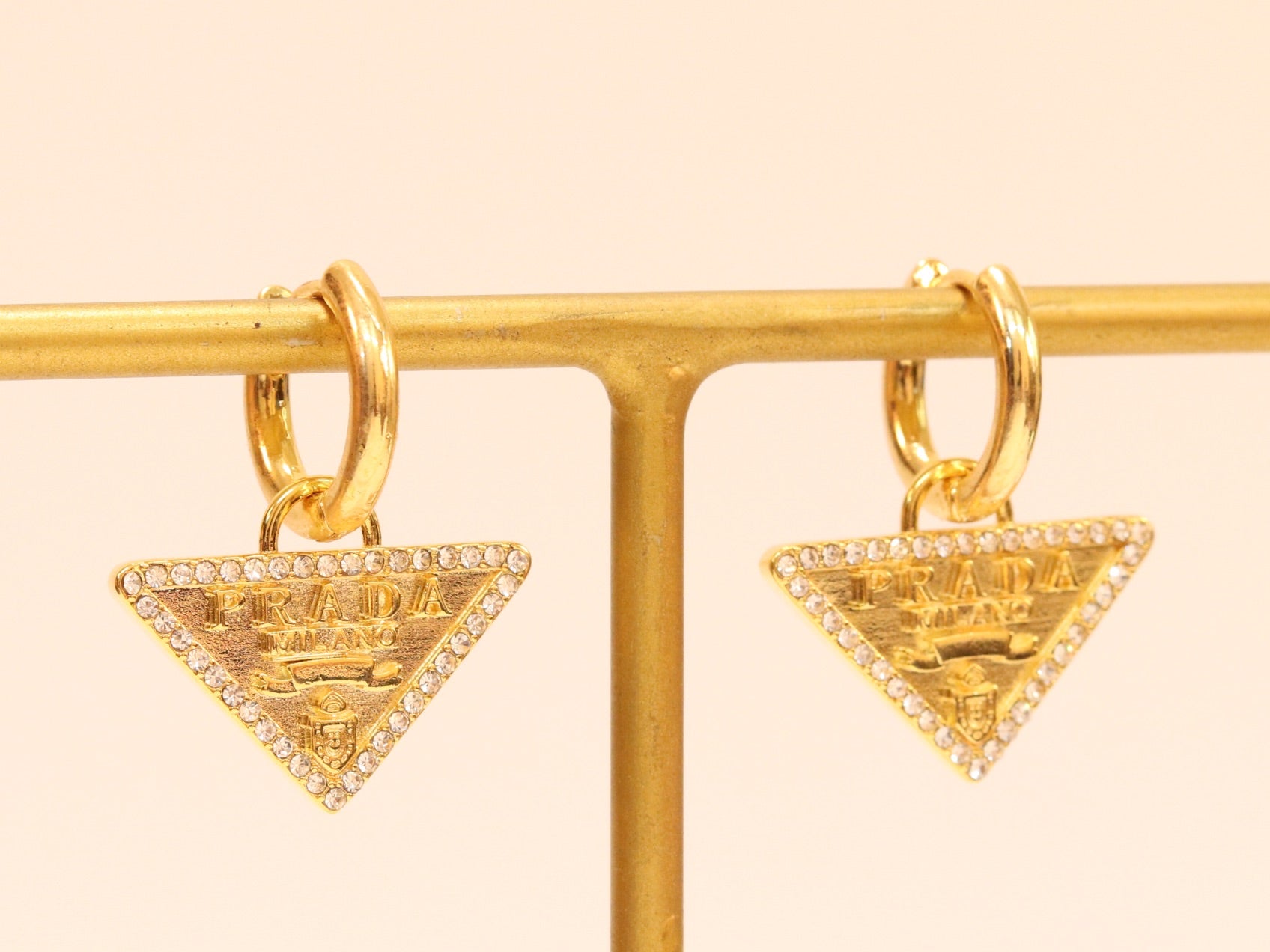 Gold Dangling Triangle earrings on small hoops with CZ