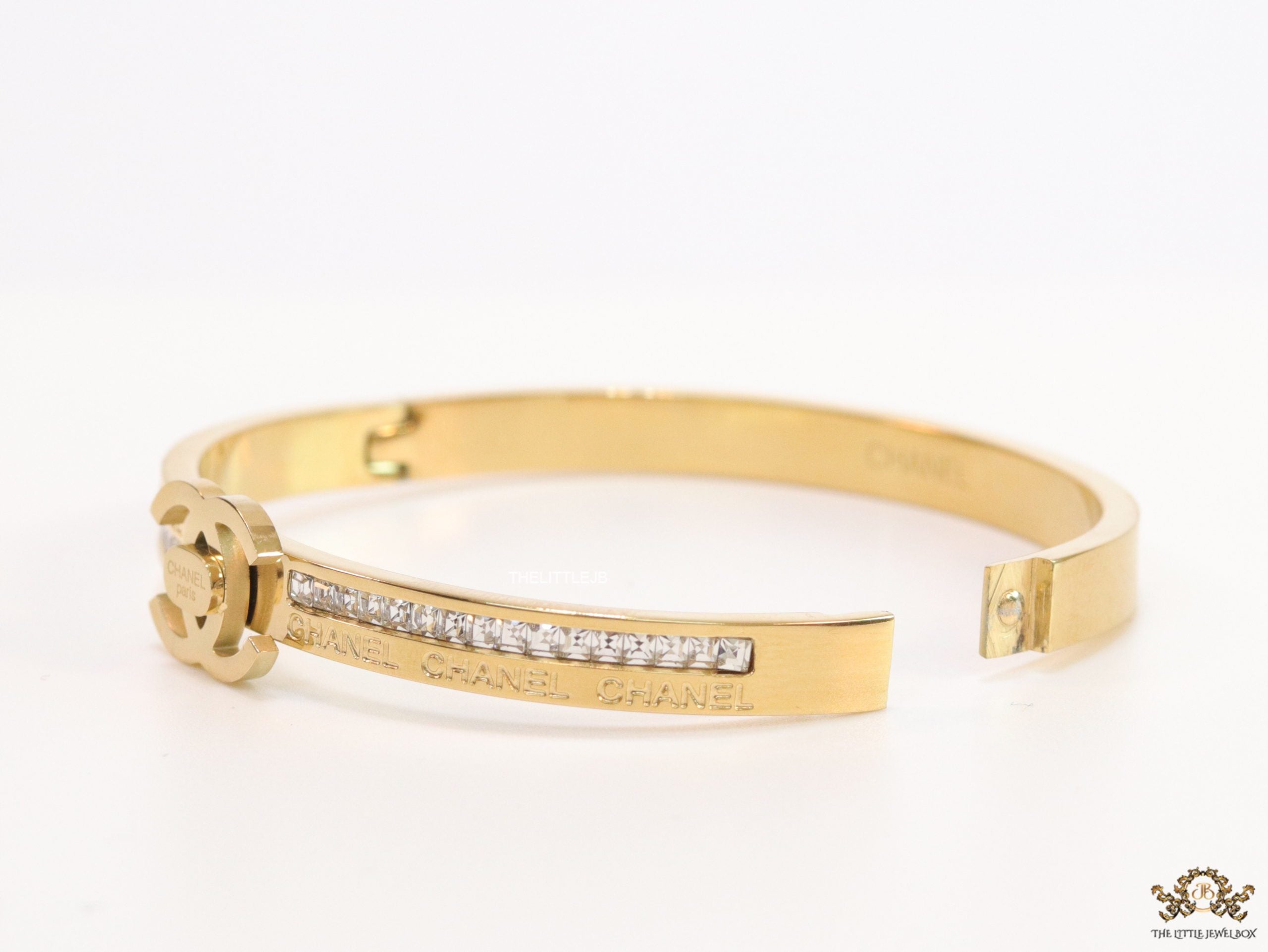 Gold plated bracelet with cz, inscribed alphabets and twin disc motif