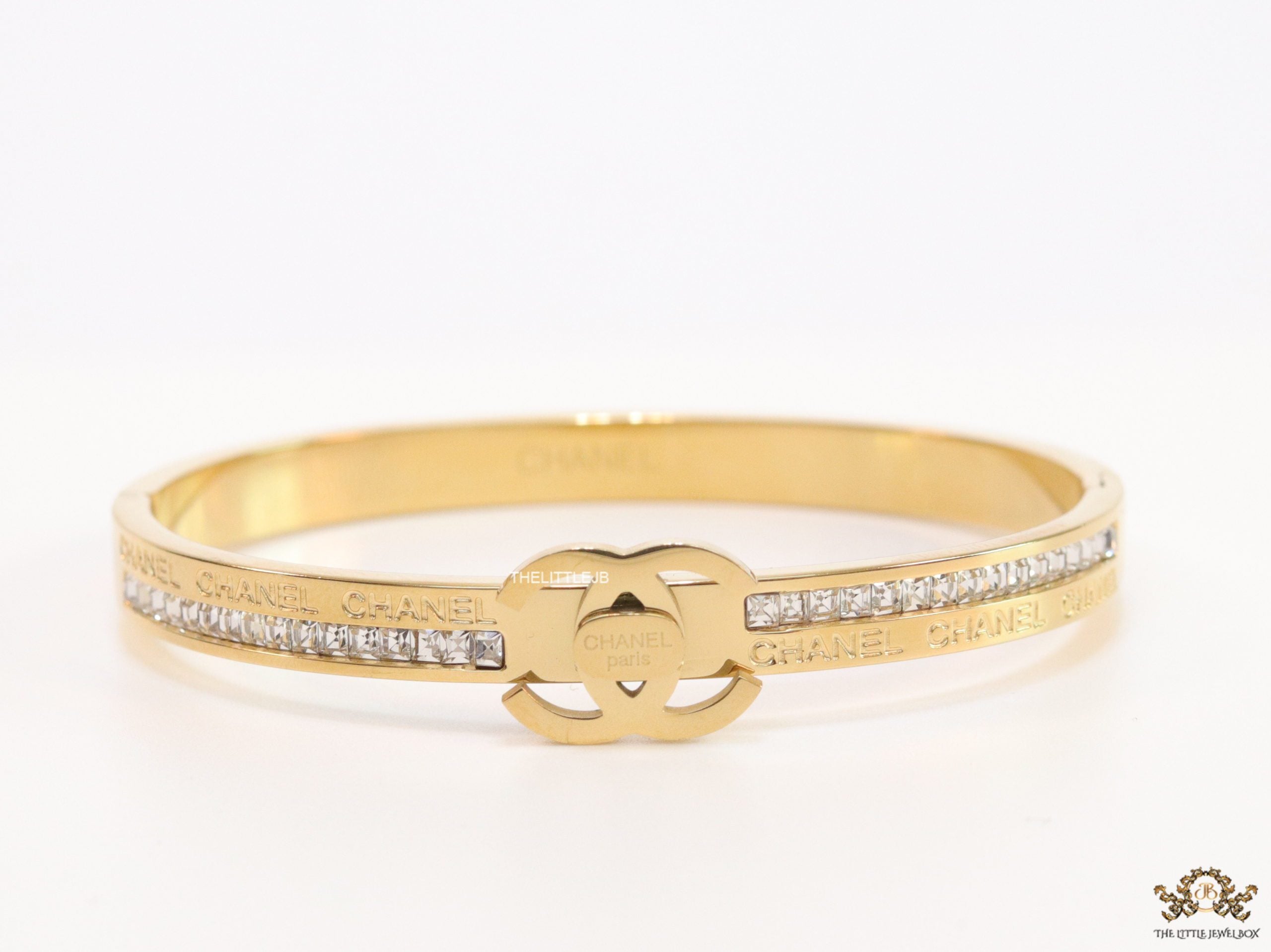 Gold plated bracelet with cz, inscribed alphabets and twin disc motif