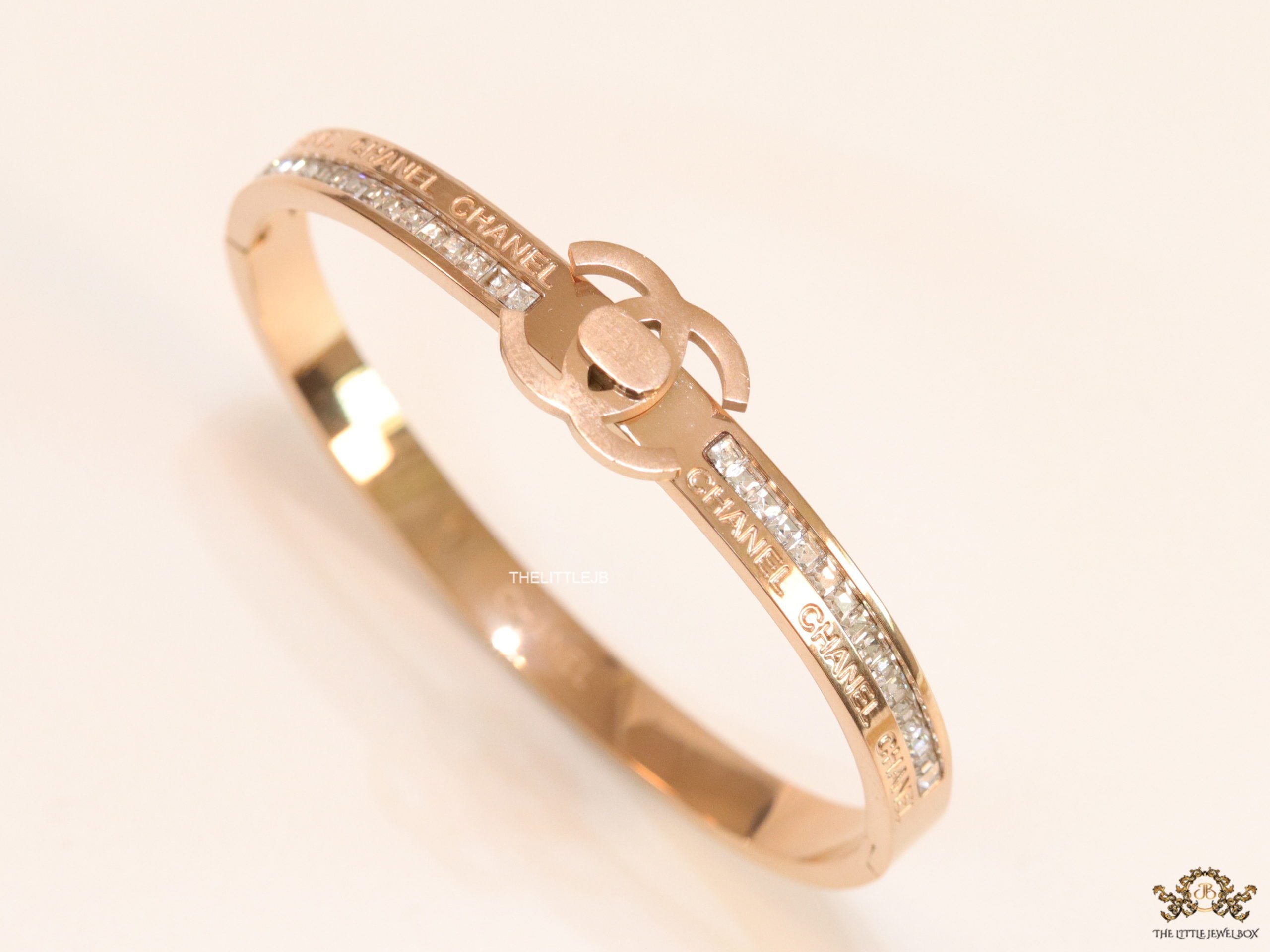 Rose gold plated bracelet with cz, inscribed alphabets and twin disc motif