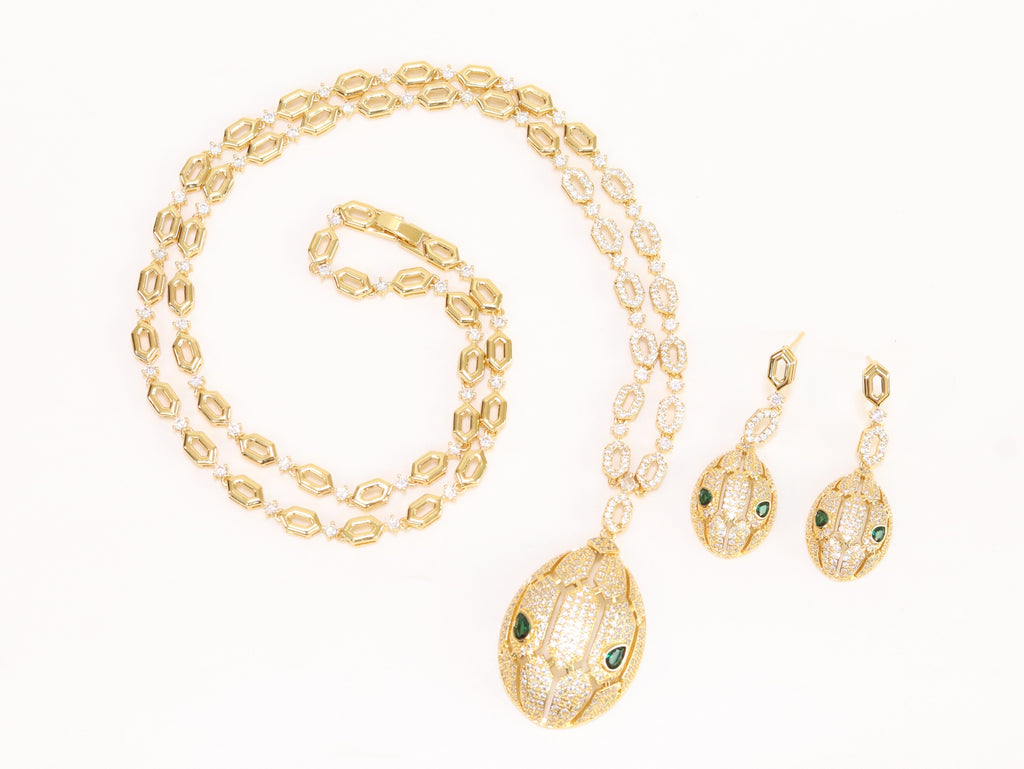 Gold Snake head pendant set with emerald detailing