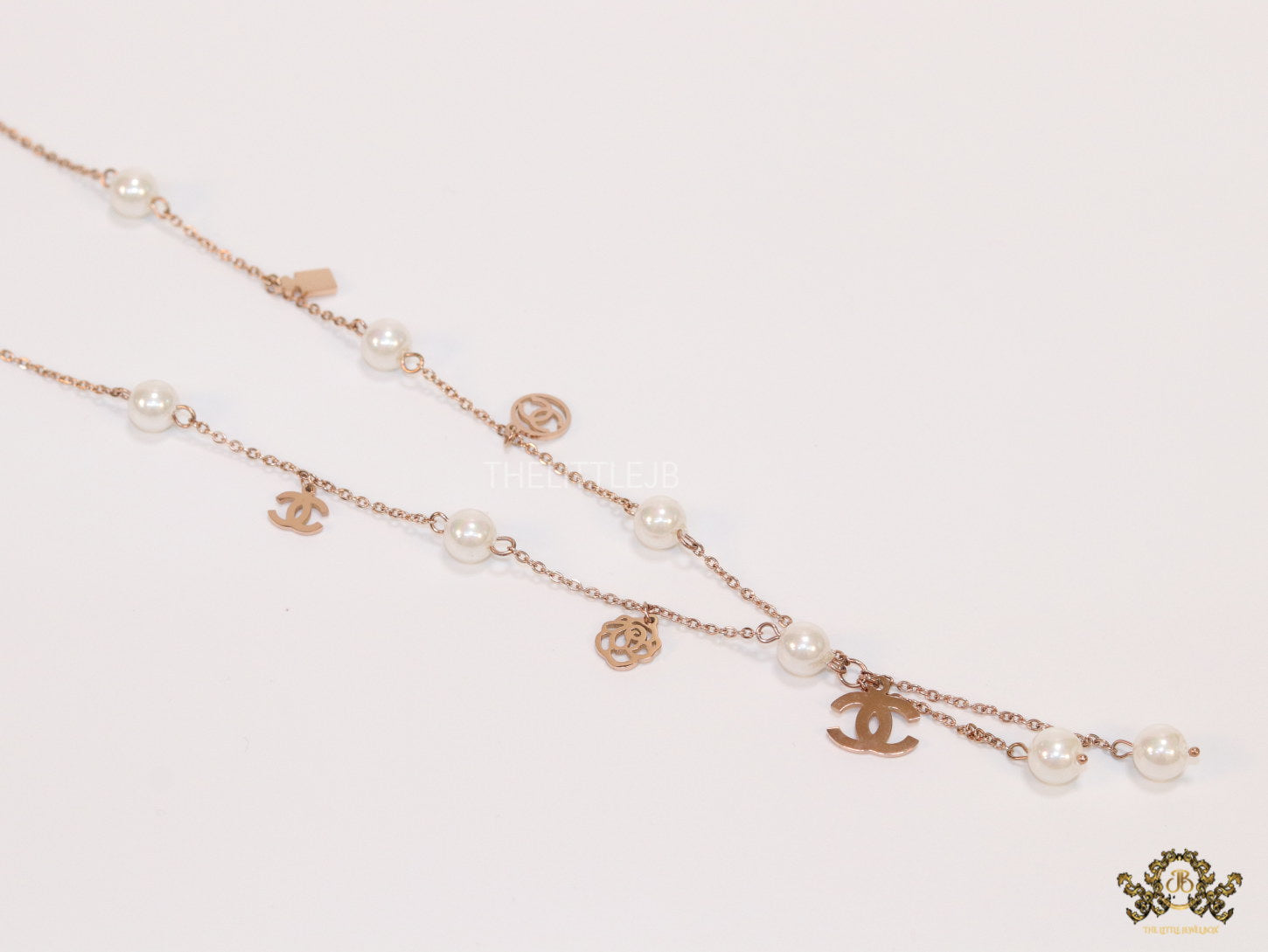 Gold chain necklace with pearls and alphabet motifs