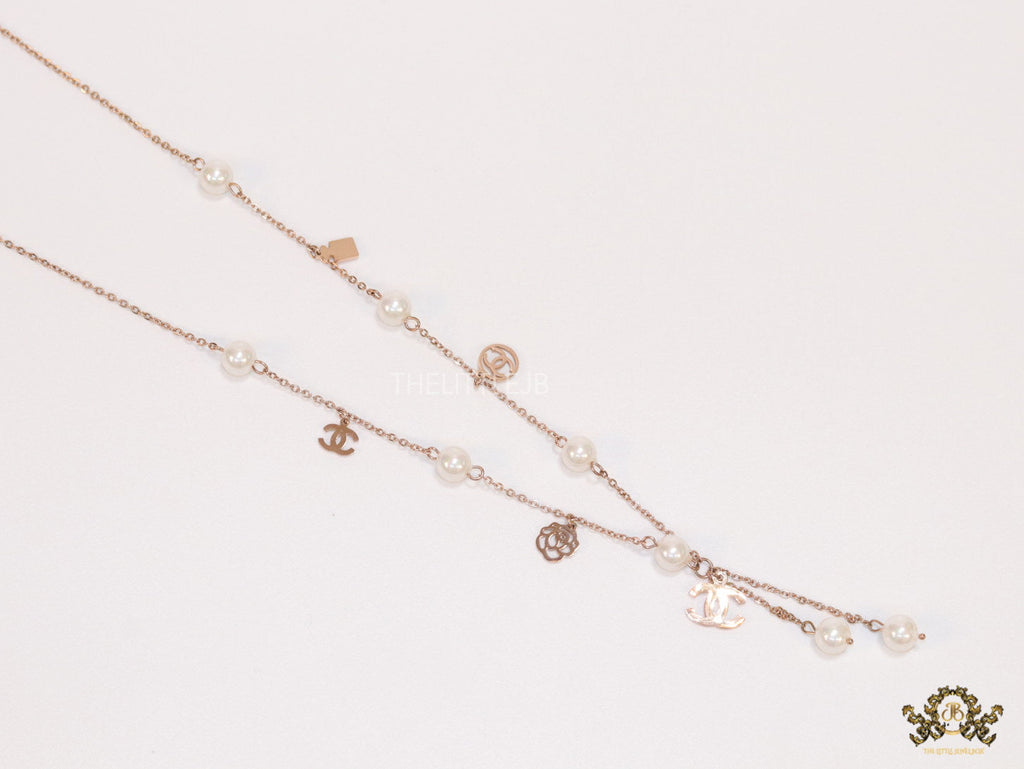 Gold chain necklace with pearls and alphabet motifs