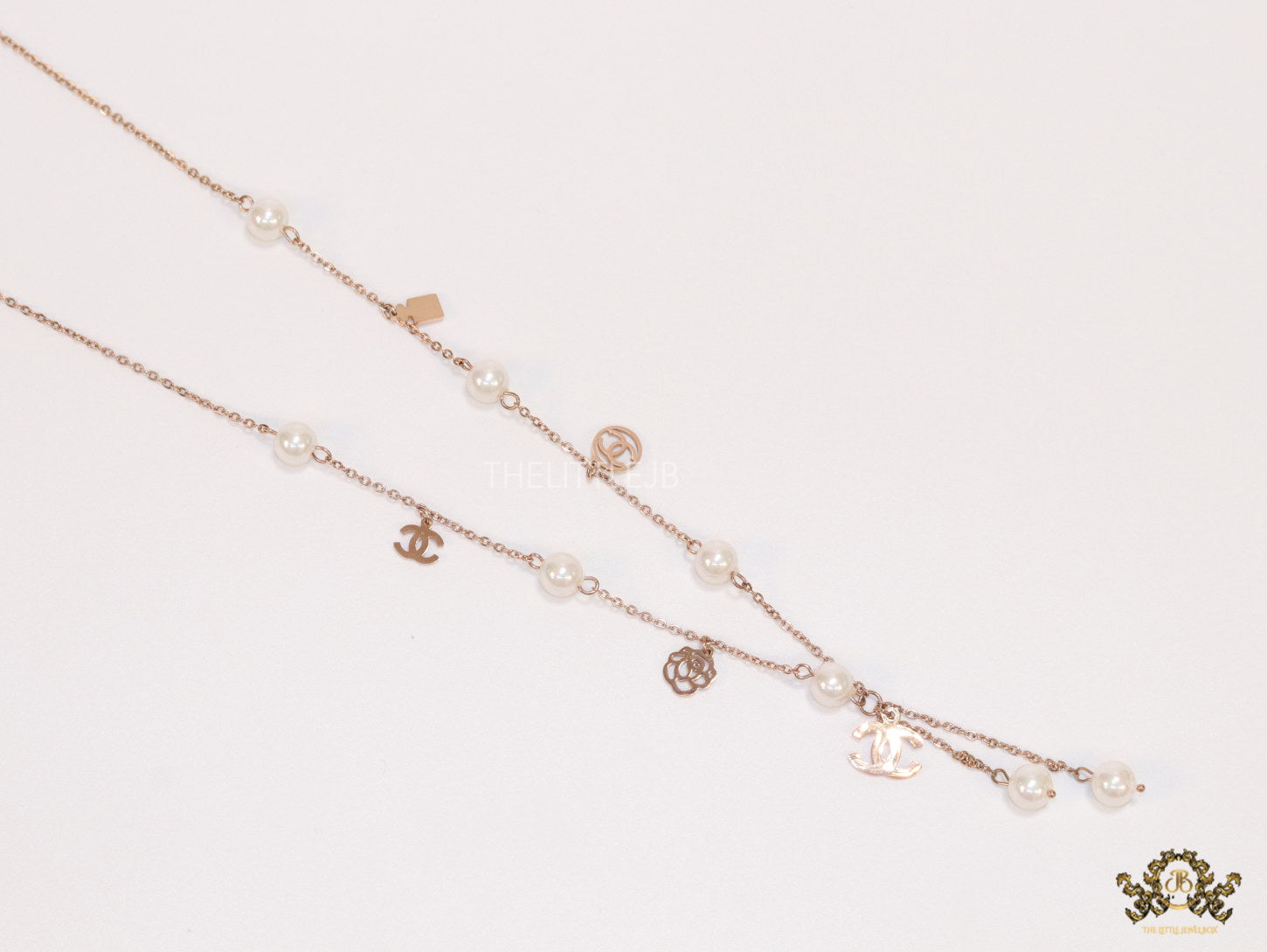 Gold chain necklace with pearls and alphabet motifs