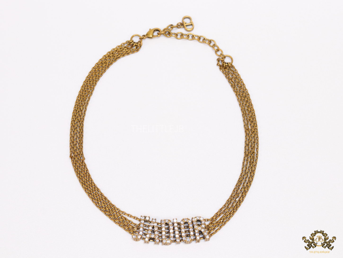Golden multi chain choker necklace with alphabet motif in cz