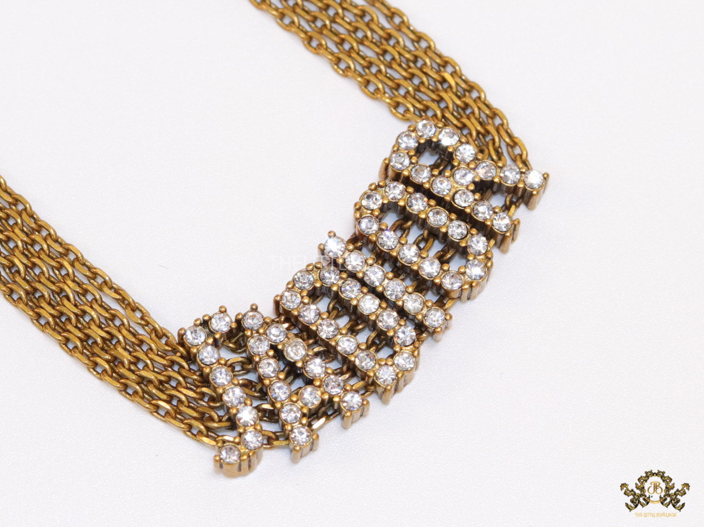 Golden multi chain choker necklace with alphabet motif in cz