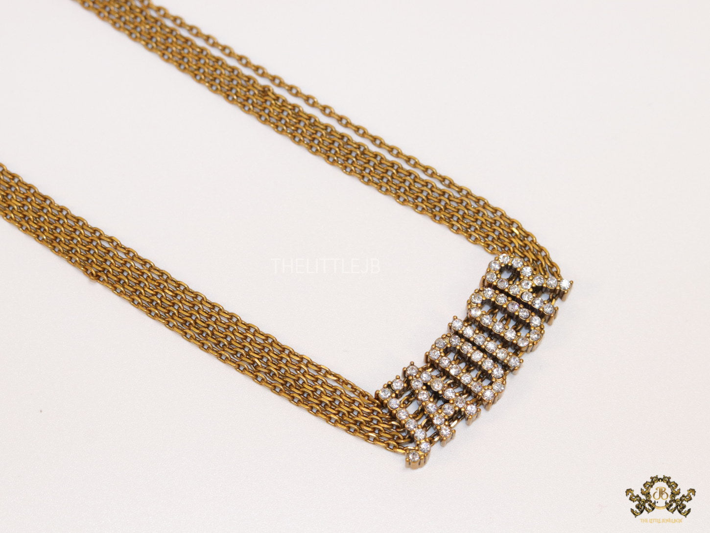 Golden multi chain choker necklace with alphabet motif in cz