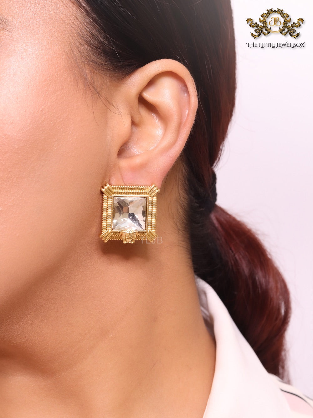 Square solitaires in gold boundaries with medusa