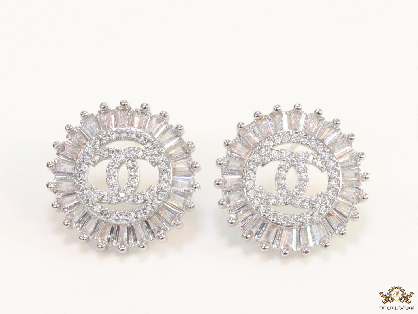 Round platinum studs lined with cz baguettes and twin C cz motif centre