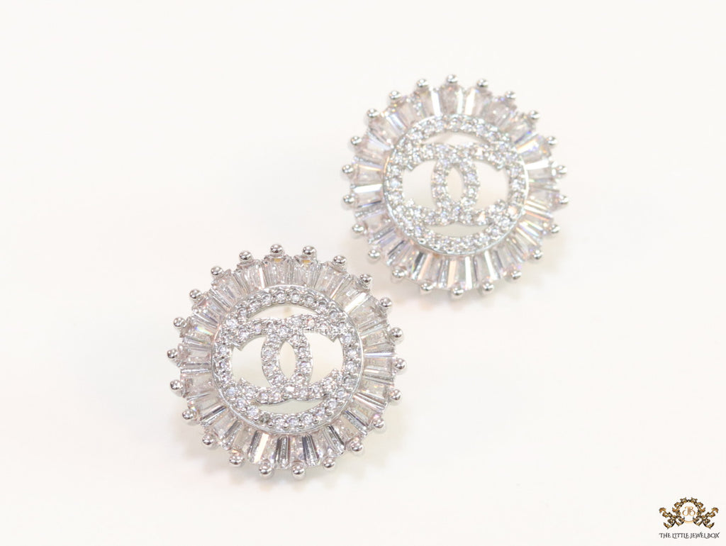 Round platinum studs lined with cz baguettes and twin C cz motif centre