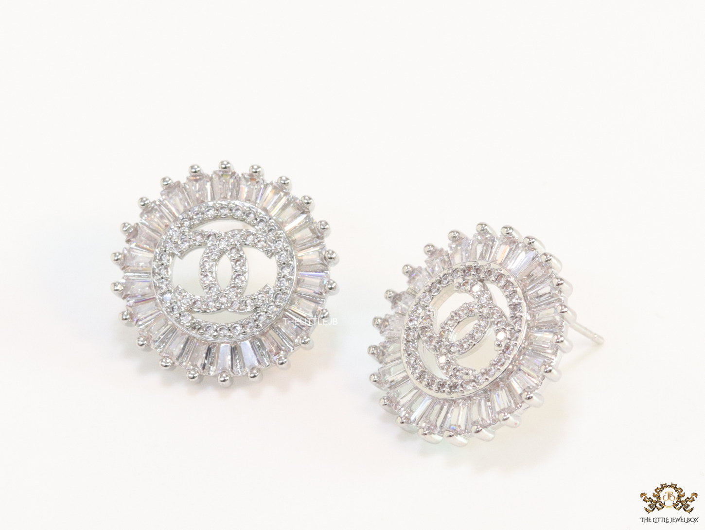 Round platinum studs lined with cz baguettes and twin C cz motif centre
