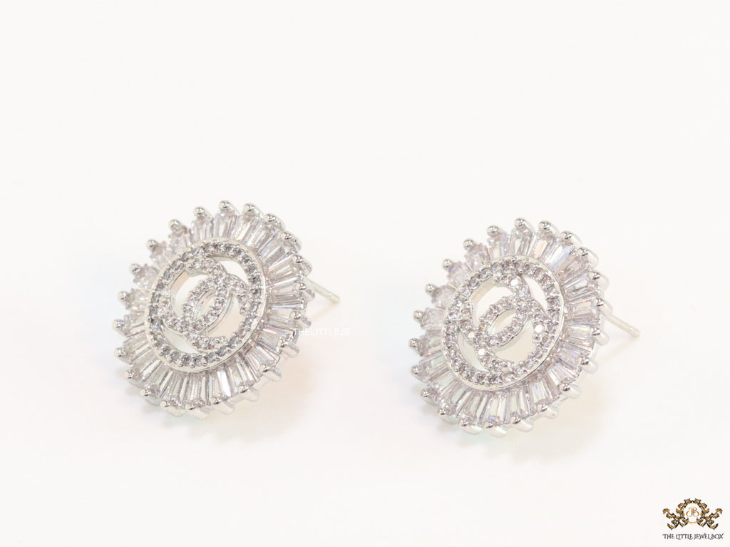 Round platinum studs lined with cz baguettes and twin C cz motif centre
