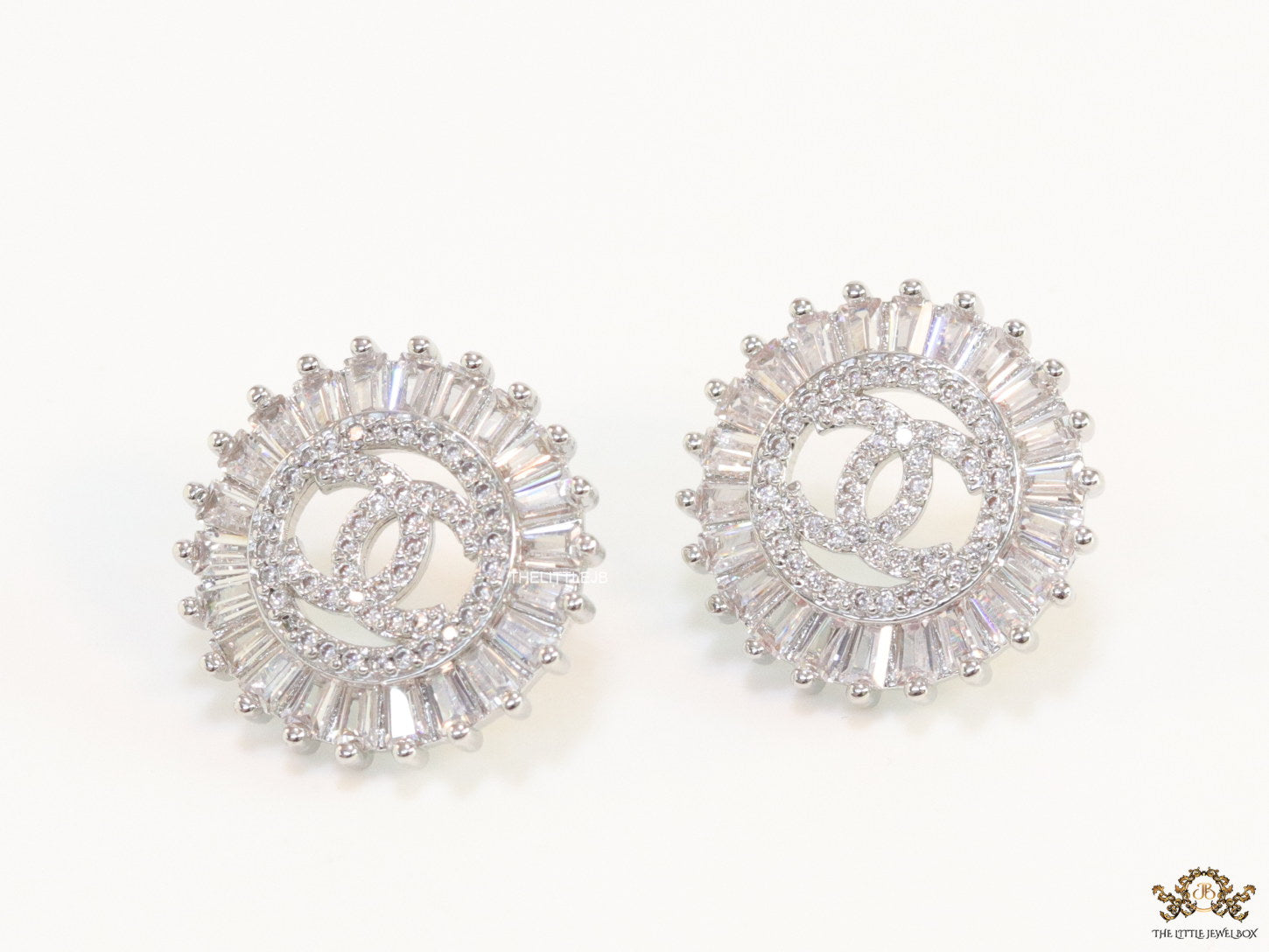Round platinum studs lined with cz baguettes and twin C cz motif centre