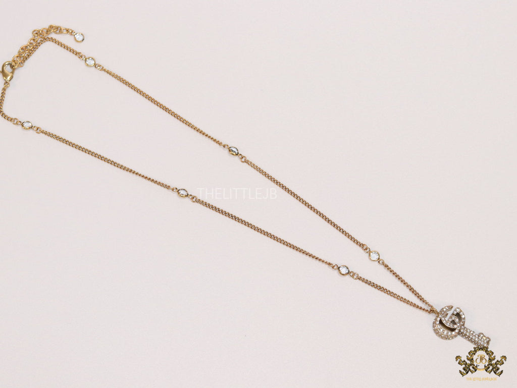 Gold plated chain necklace with cz G and key pendant