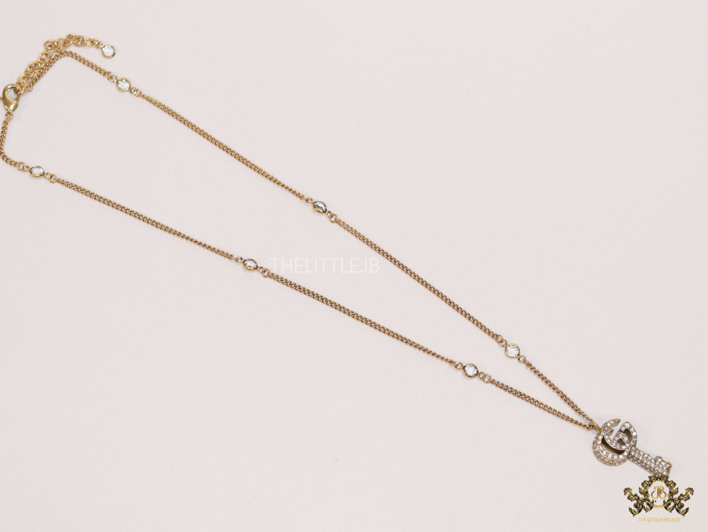 Gold plated chain necklace with cz G and key pendant