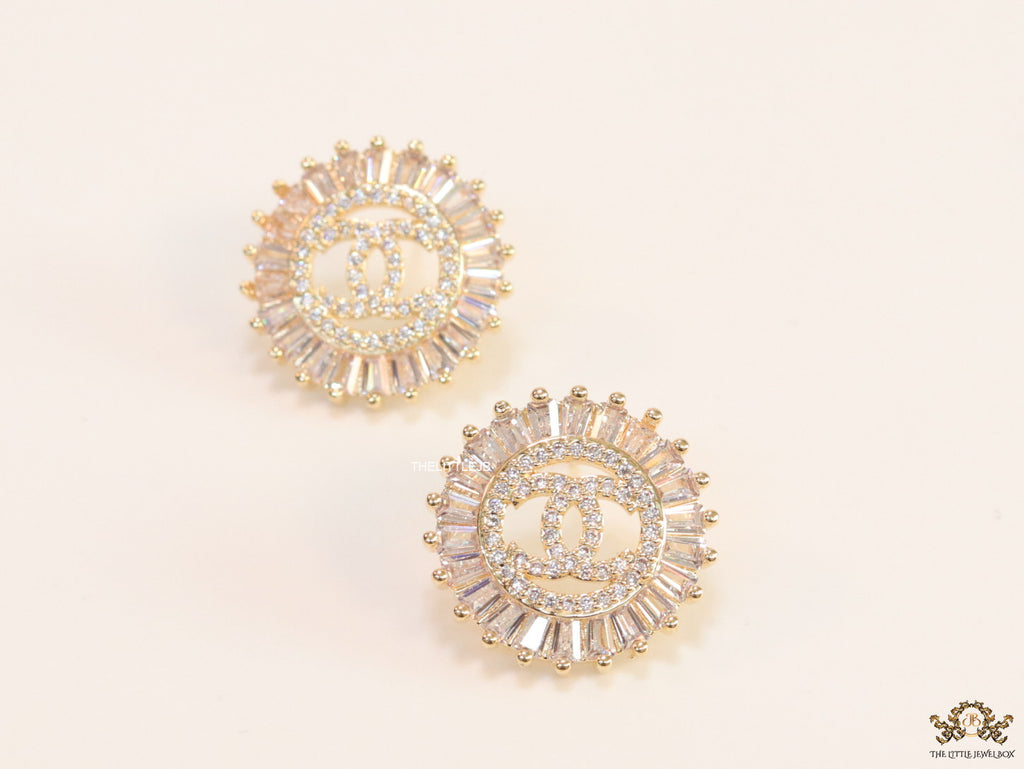 Round gold studs lined with cz baguettes and twin C cz motif centre