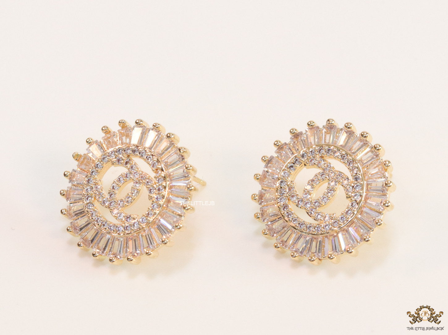 Round gold studs lined with cz baguettes and twin C cz motif centre