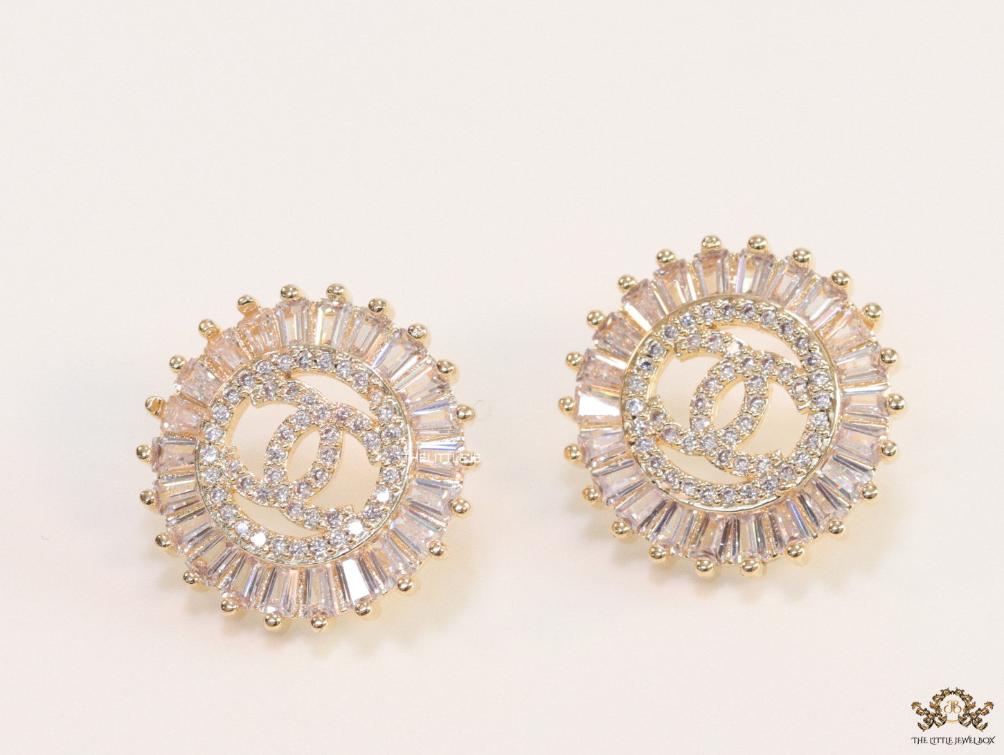 Round gold studs lined with cz baguettes and twin C cz motif centre