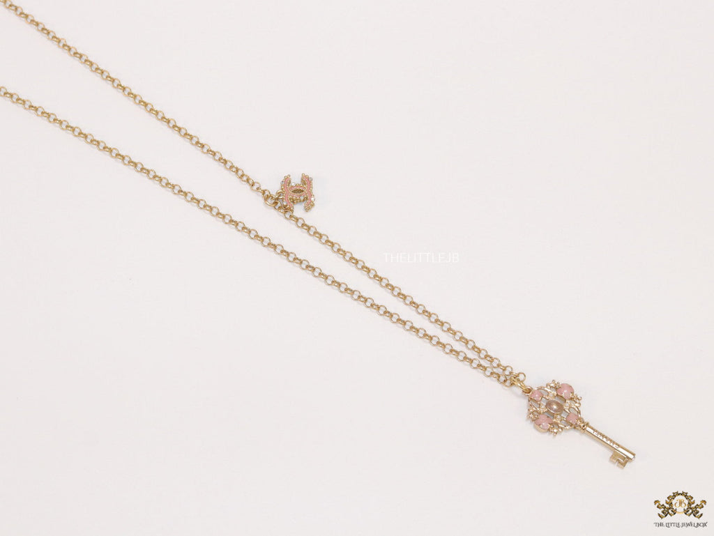 Golden chain necklace with pink clovers studded key pendant
