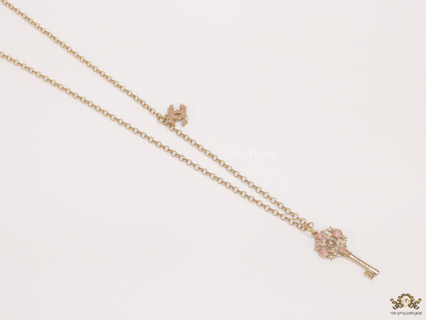 Golden chain necklace with pink clovers studded key pendant