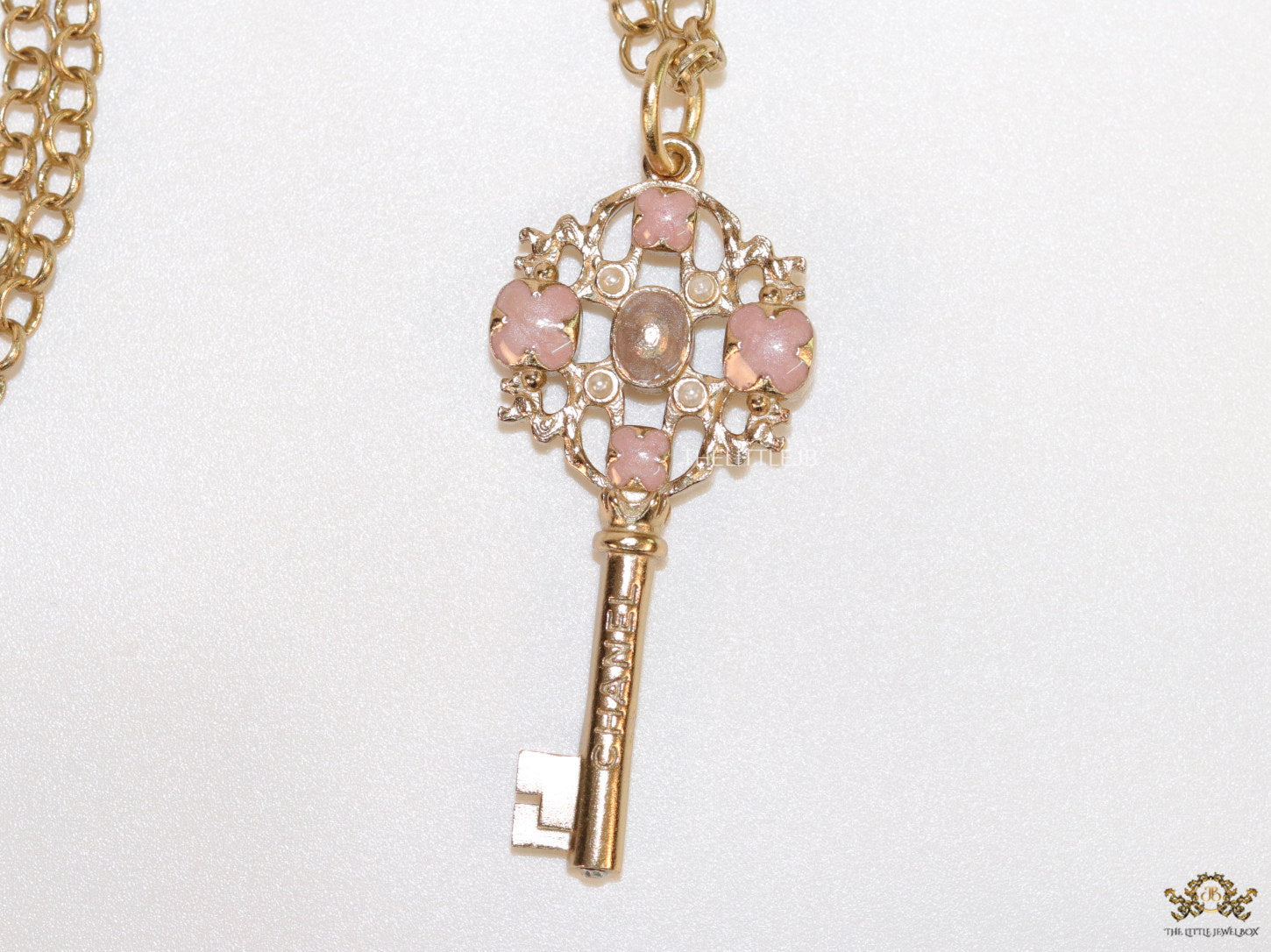 Golden chain necklace with pink clovers studded key pendant