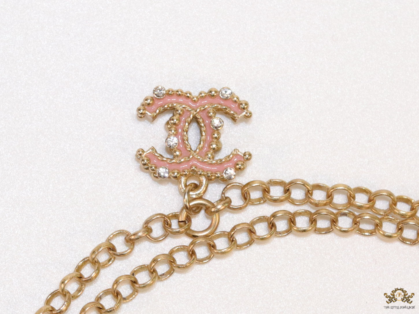 Golden chain necklace with pink clovers studded key pendant