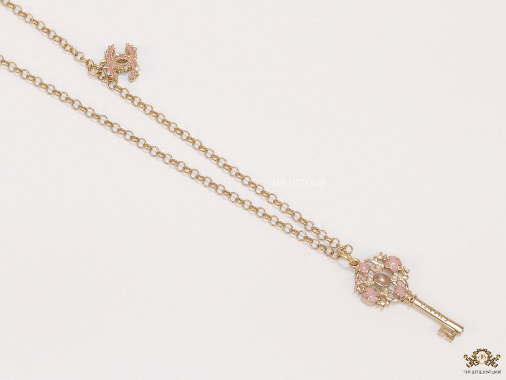 Golden chain necklace with pink clovers studded key pendant