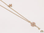 Golden chain necklace with pink clovers studded key pendant