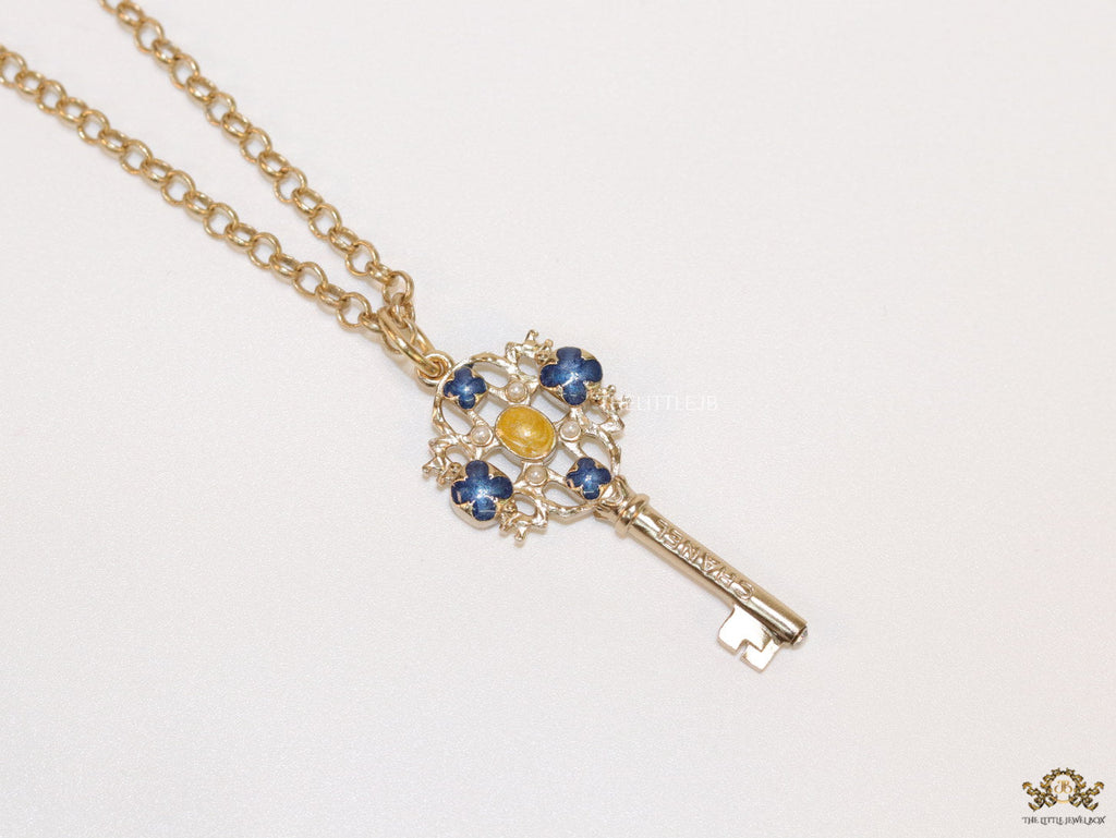Golden chain necklace with blue clovers studded key pendant