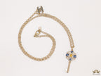 Golden chain necklace with blue clovers studded key pendant