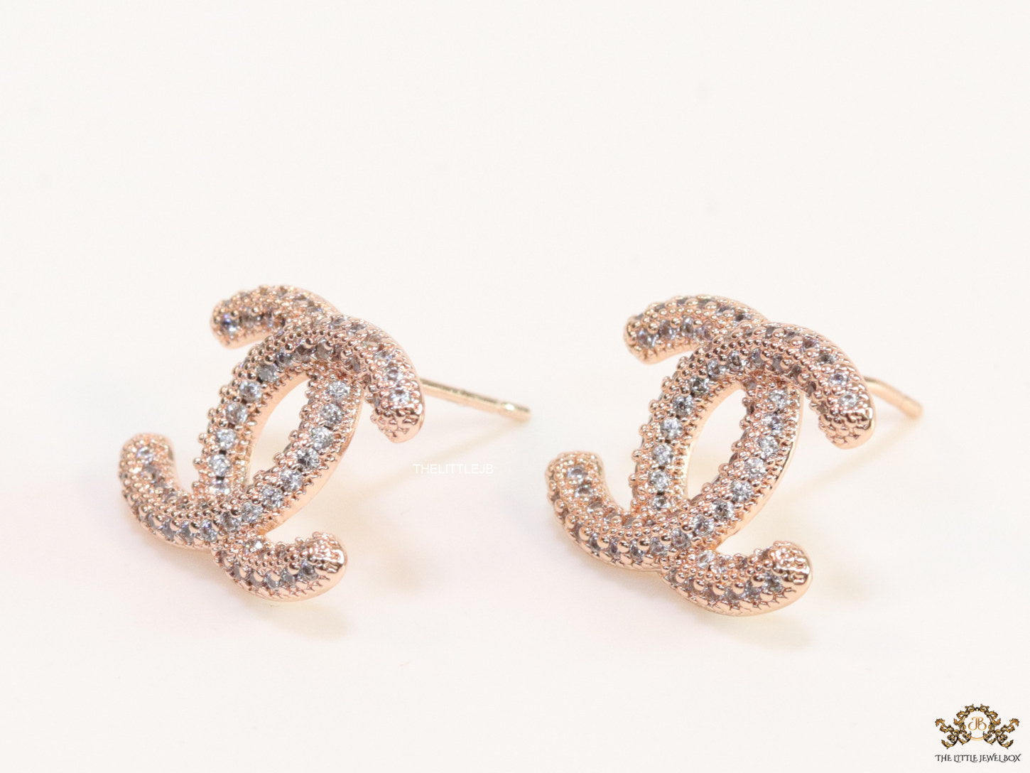 Rose gold plated twin C motif studs with cz
