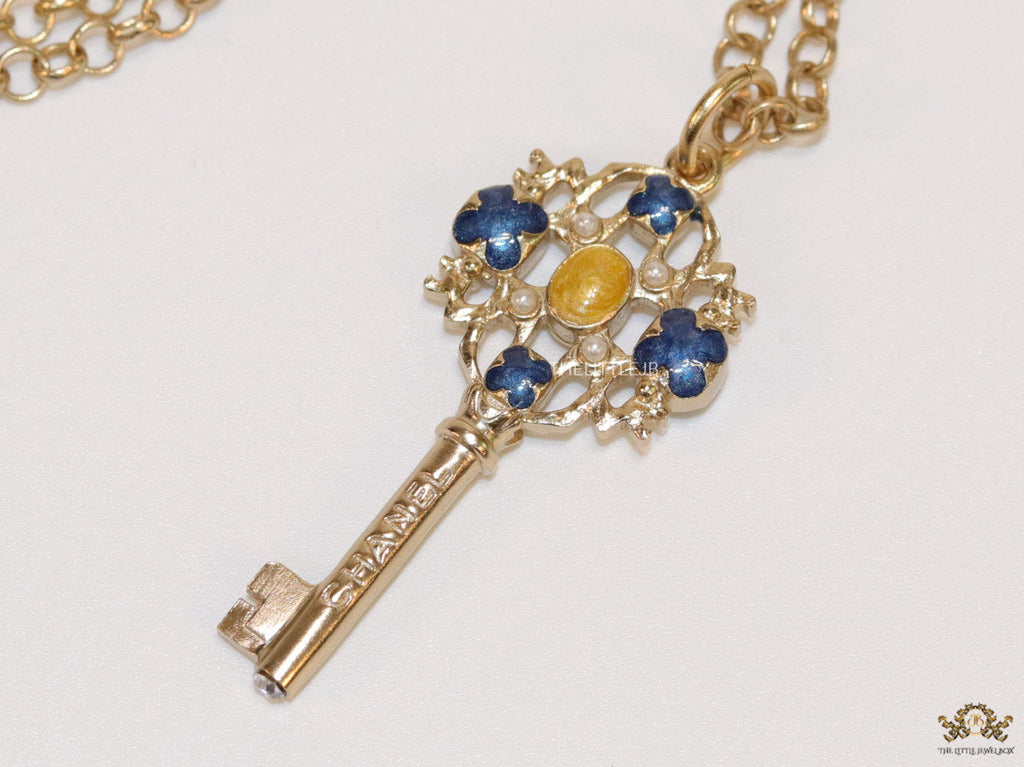 Golden chain necklace with blue clovers studded key pendant