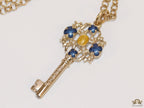 Golden chain necklace with blue clovers studded key pendant