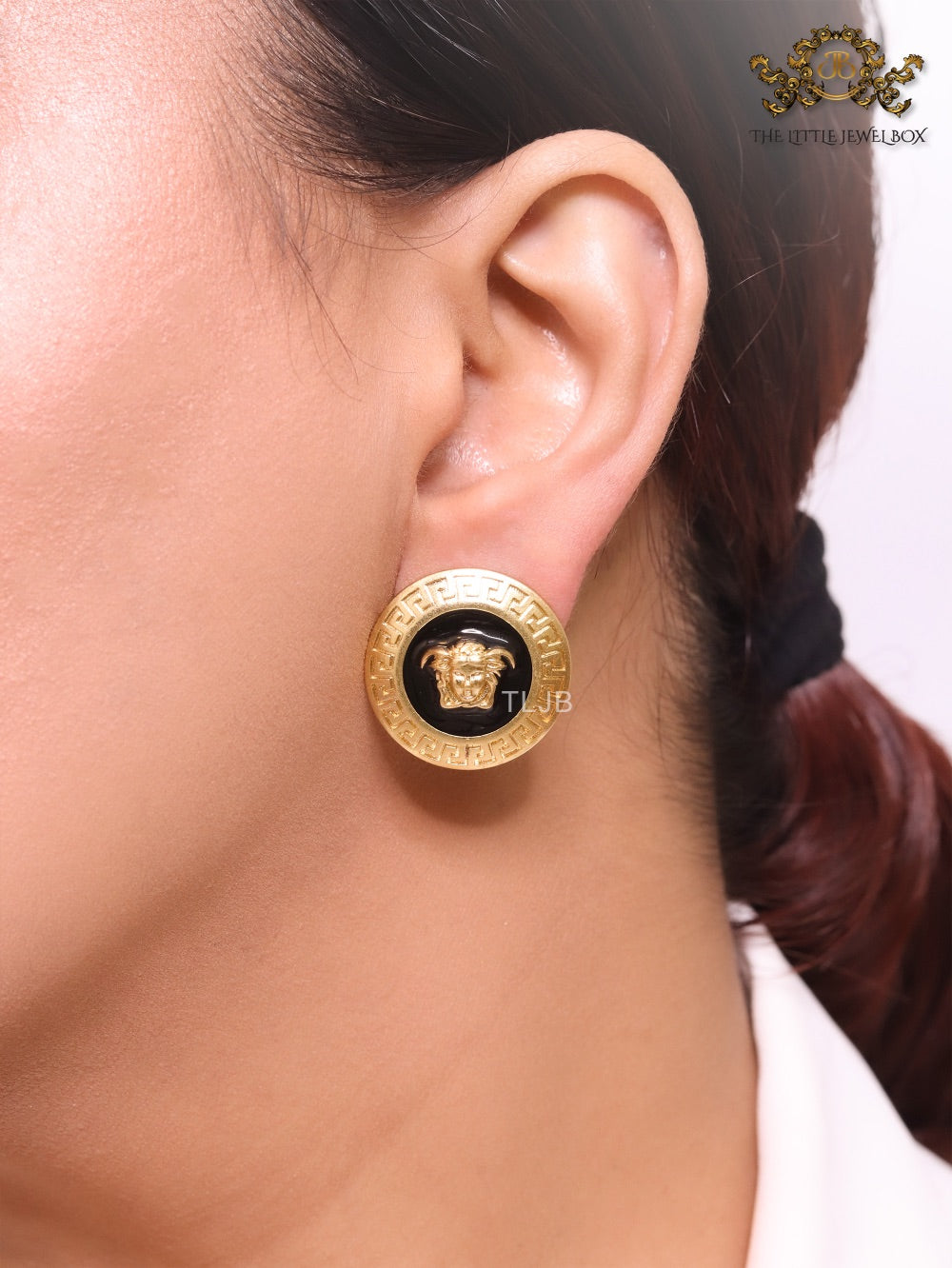 Gold round medusa motif black enamel earrings