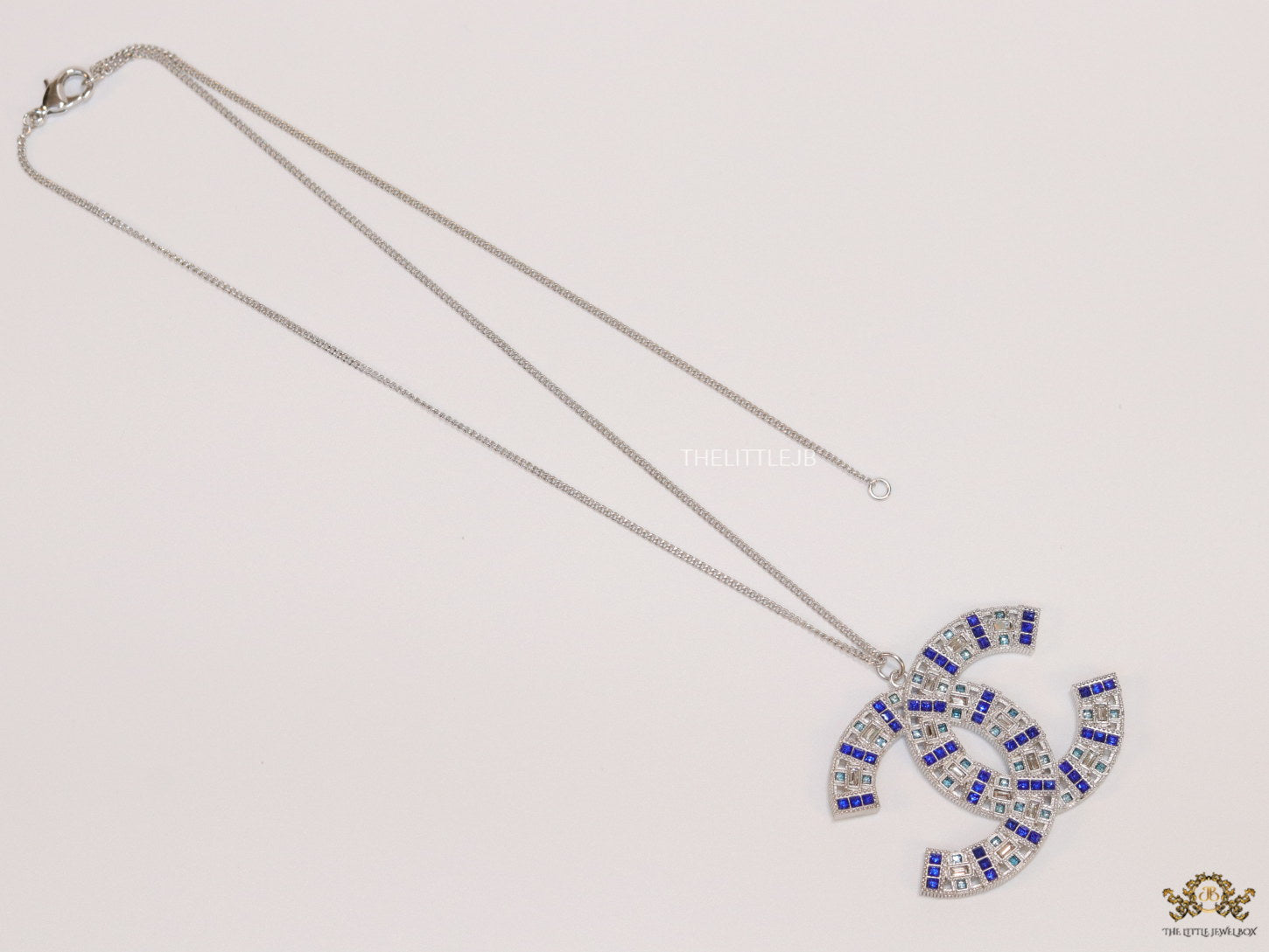 Platinum chain alphabet necklace with coloured cz