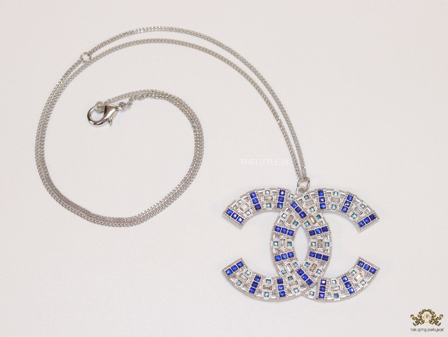 Platinum chain alphabet necklace with coloured cz