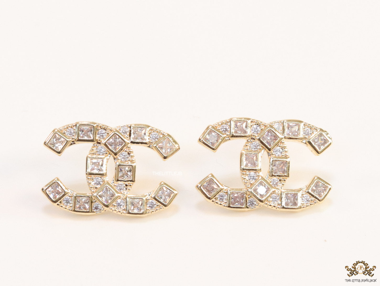Golden twin C motif studs with fancy cut cz